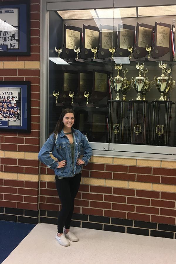 Samantha Schaffer (10) poses outside of the dance trophy case.  Schaffer won one of these while she was still a part of the team.
