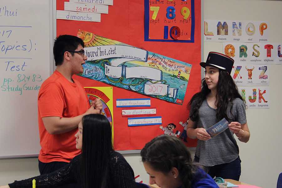 Theodore Mantis (10) tells Autumn Flenar (10) the significance behind the French police hat she is wearing. Flenar won the prize of wearing the hat for the duration of the meeting after being the first to complete a crossword puzzle. 
