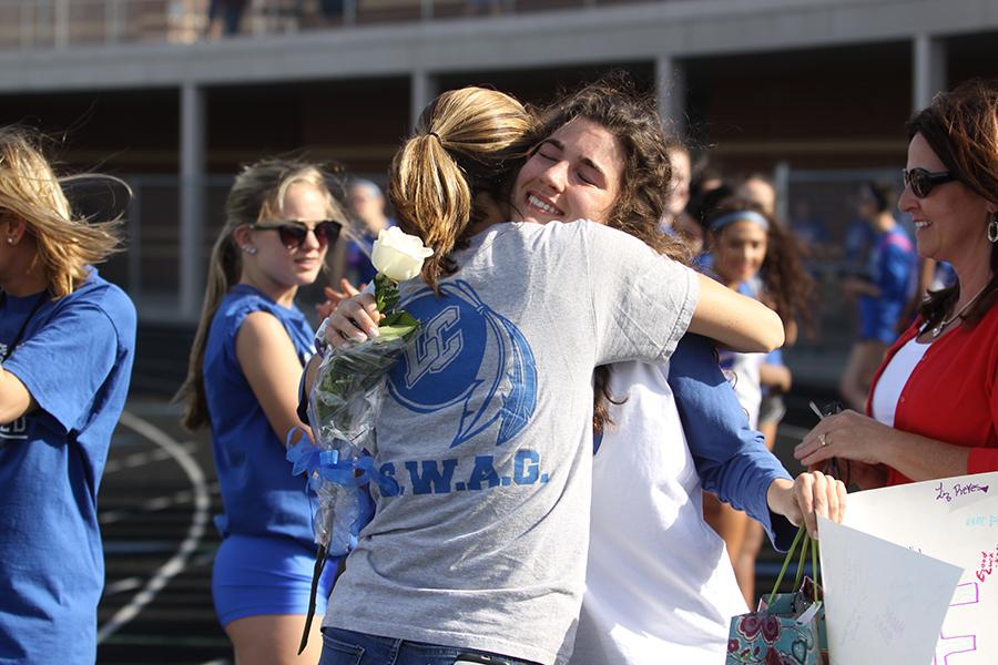 Ellie Keith (12) hugs her coach in a sentimental moment. Keith ran track and cross country for Lake Central.