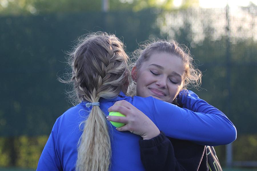 The varsity girls tennis team won at their last home match of the season. Claire Gronek (11) hugged Sky Martens (12) after her and her doubles’ partner, Anna Wachowski (12), clinched the win against Valparaiso.