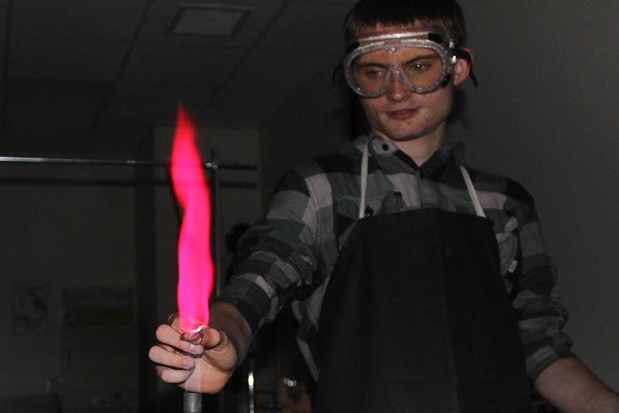 Joseph Kane (11) puts the chemical copper into the flame. Kane was in the ACP 2 Chemistry class.