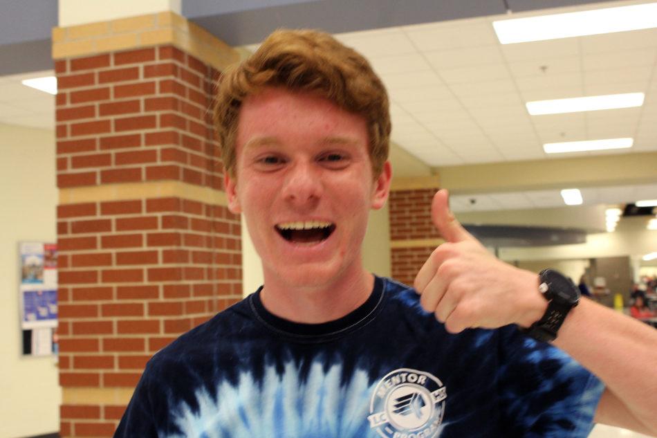 Carter Goldman (11) gives a thumbs up to signify the success of Open House. He was a volunteer who helped parents locate the classes they needed to go to.
