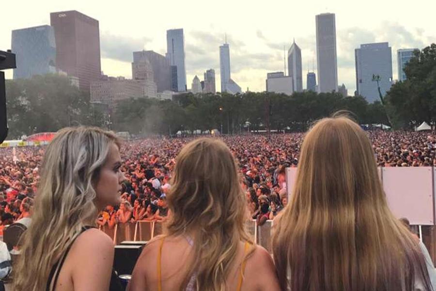 Lara Mitchell [middle] (12) stood in front of the crowd at Lollapalooza. Mitchell has gotten to meet various artists due to the backstage passes that she receives from her dad.

