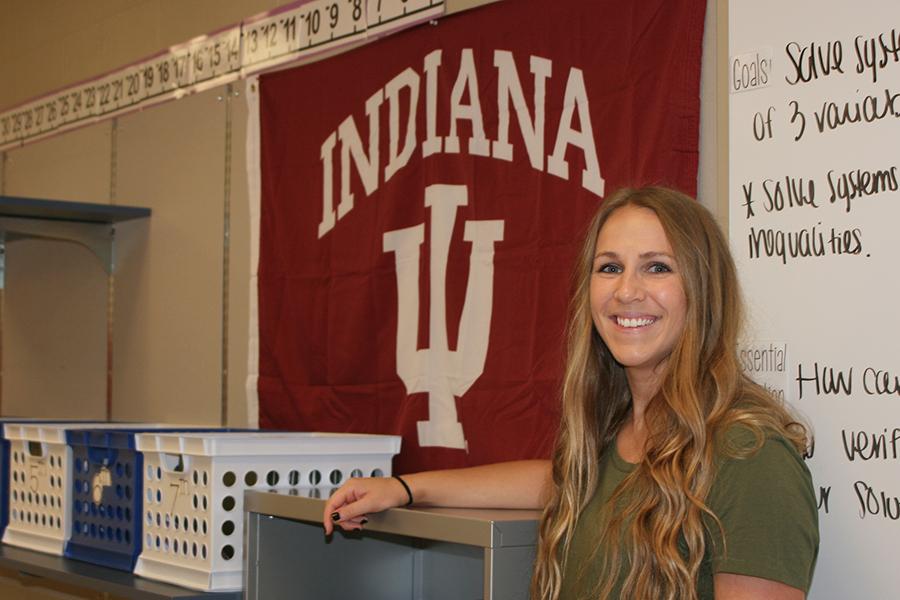 Mrs. Megan Banashak, Mathematics, poses next to her Indiana University banner. Indiana University was the college she graduated from.  