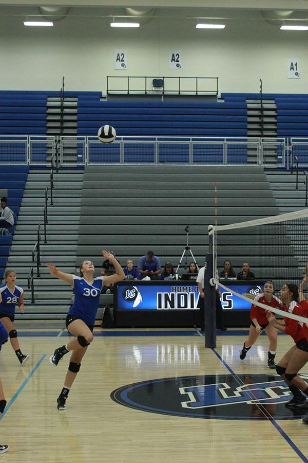 Lily Robinson (9) prepares to spike the volleyball. Robinson followed the ball and prepared to jump.