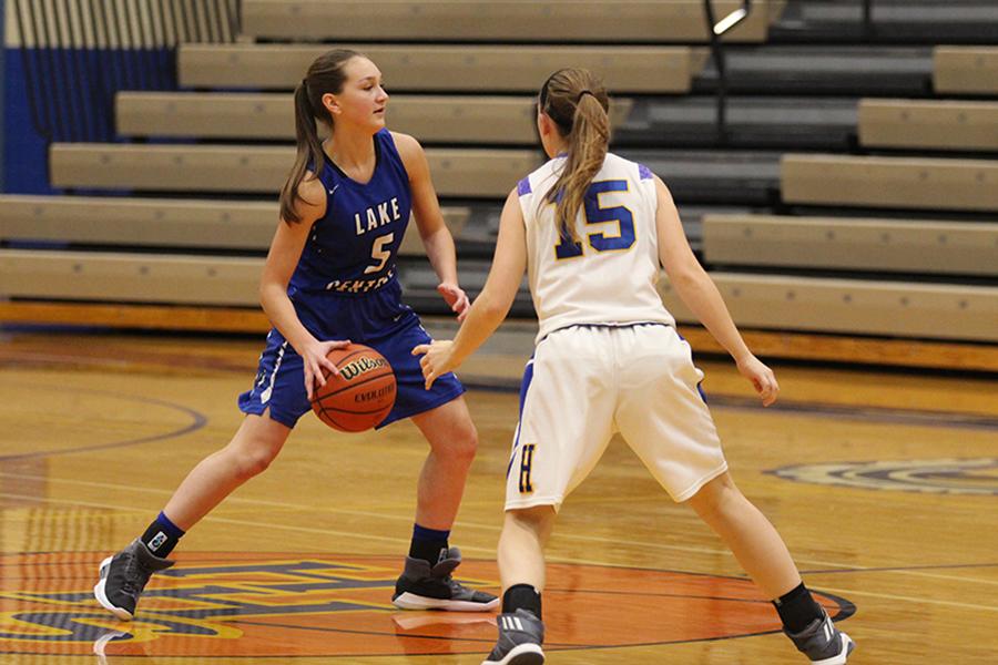 Jennifer Tomasic (9) passes the ball to a teammate across the court. The team had a score of 24-2 by halftime.