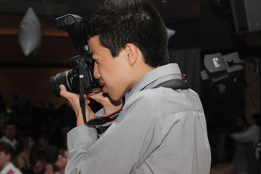 Joshua Chen (10) takes pictures during Prom. Chen was given the opportunity to join Publications as a freshman.