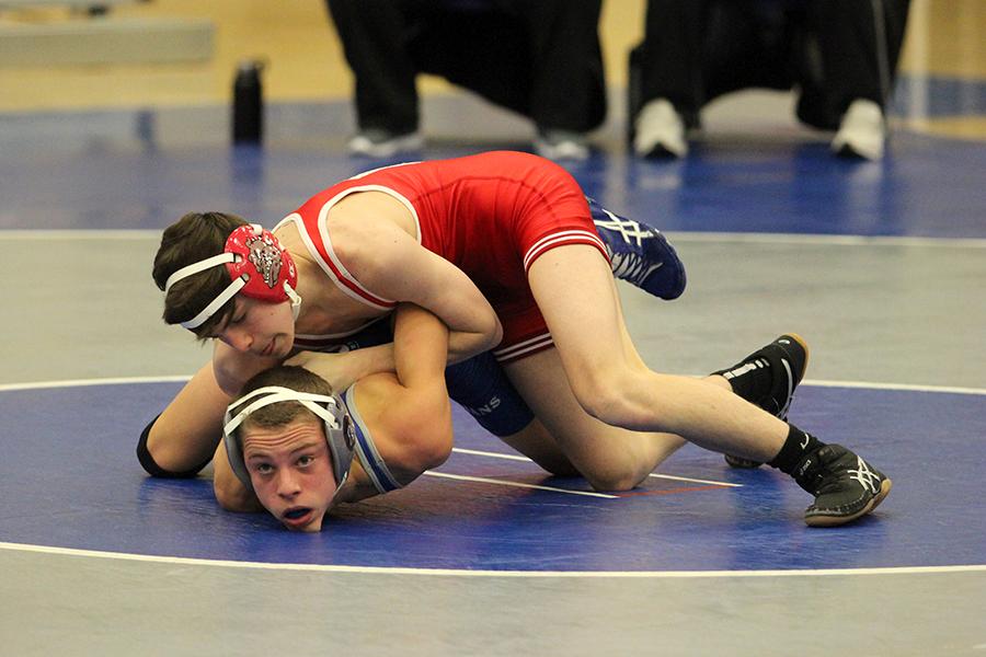 Danny McGrath (9) gets pinned down by a Crown Point opponent. The boys lost with a score of 13-53.