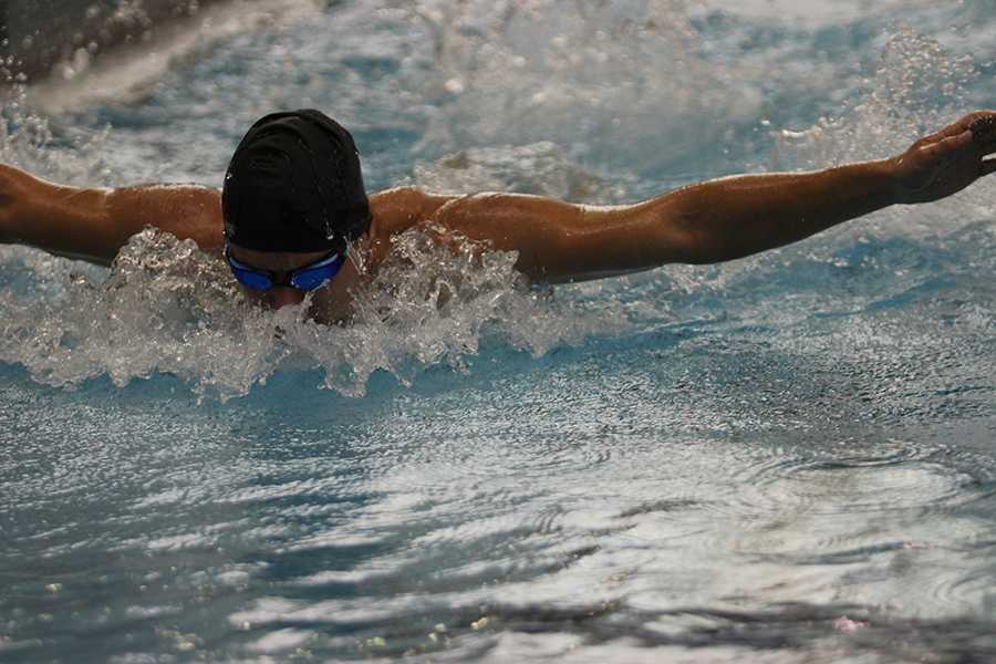 Michael Perich (10) takes a breath as he swims his first of many events against Highland. Perich started swimming freshman year and made it to varsity his sophomore year.