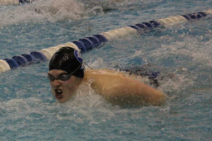 Swimming the 100 fly, Joshua Burton (10) takes a gasp of air. In past meets, Burton swam the 100 backstroke, but Coach Jeff Kilinski has been placing him more in the 100 fly. 