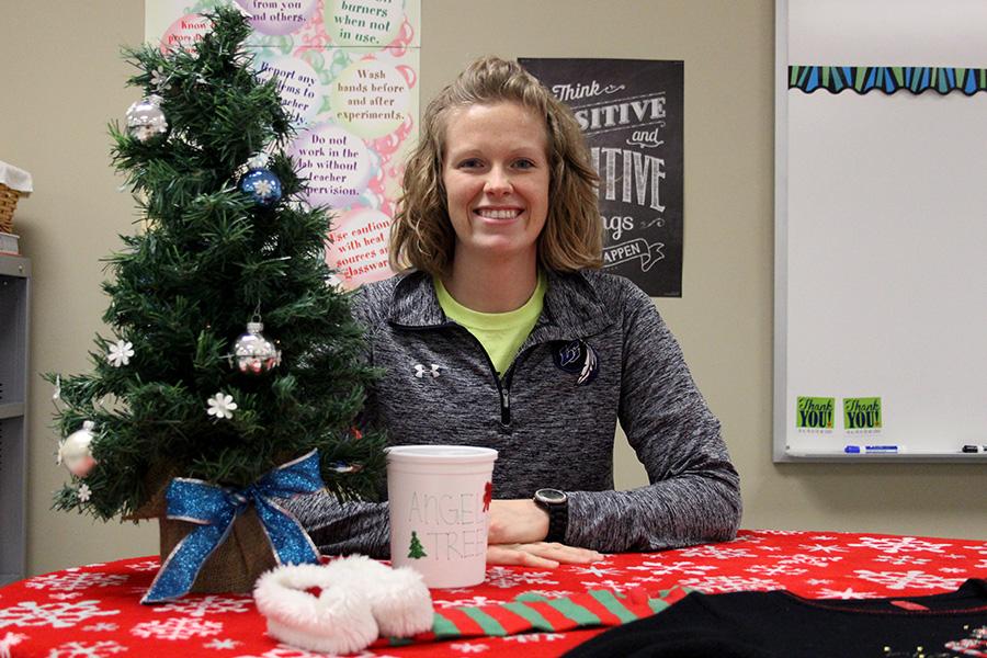 Mrs. Katelin Ellis, Science, smiles next to an angel tree bucket. Mrs. Ellis was able to help at least 40 angels between her and her classes. 
