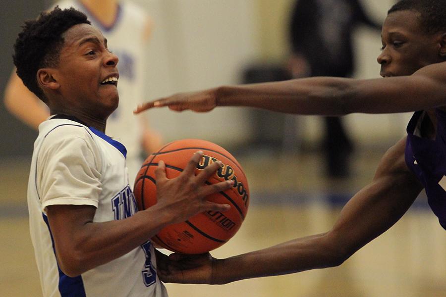  Caleb Dotson(9) tries to keep the ball away from the other team. The boys lost to Merrillville 45-54.