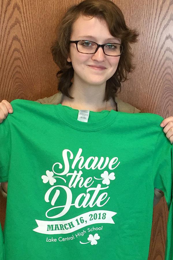 Maya McCants (12) holding up a St. Baldrick’s shirt. Shirts can purchase during lunch in Main Street.