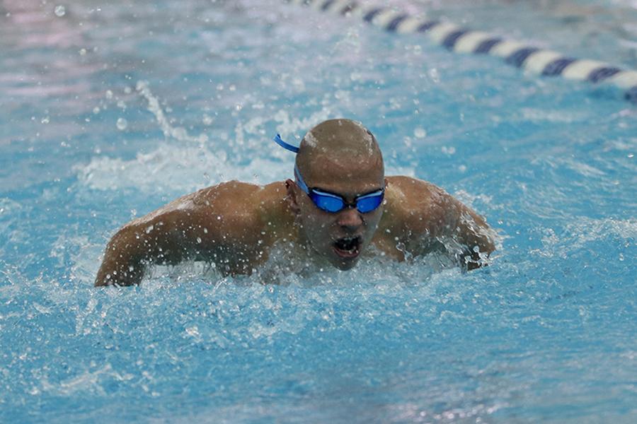 Michael Perich (12) competes in the 100-yard butterfly event. Perich competed in two events at finals.