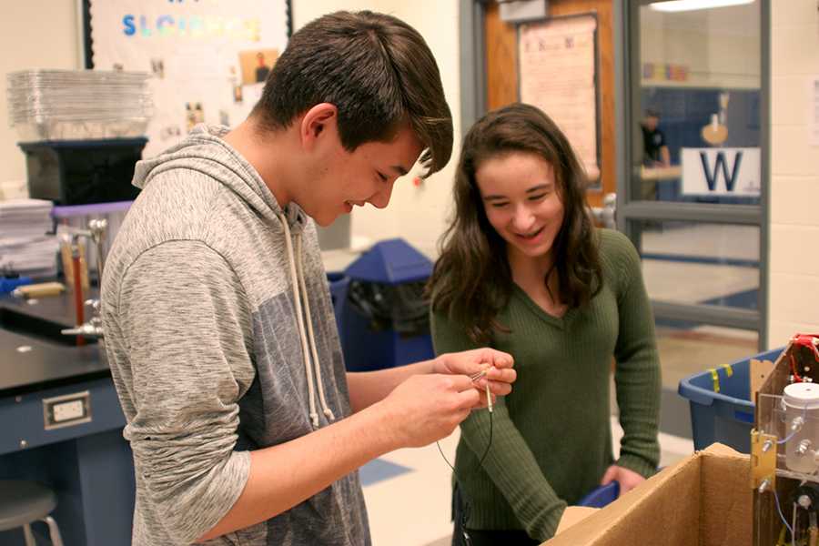 Jordan Sprague (11) and Madison Mullens (11) work on using electricity to create a reaction. They worked on creating a light reaction using electricity.