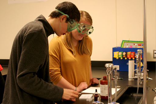 Ian Butler (10), along with partner Adriana Klein (10), prepare for their lab by reading the direction. They analyzed the problem and began setting up their experiment. 