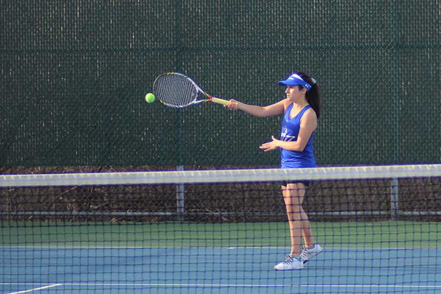  Briana Garcia (10) plays singles during the match and volleys the ball over. This was Garcia’s second year being apart of the tennis team. 
