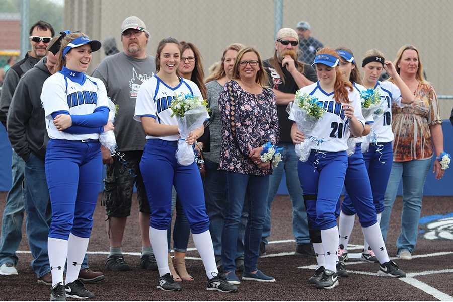 The senior girls stand on the field with their families. The girls were given gift baskets after the game was over.