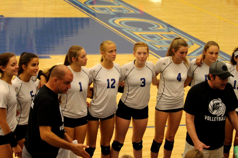 The girls huddle around each other during a time out.  They encouraged each other and listened to the coach.