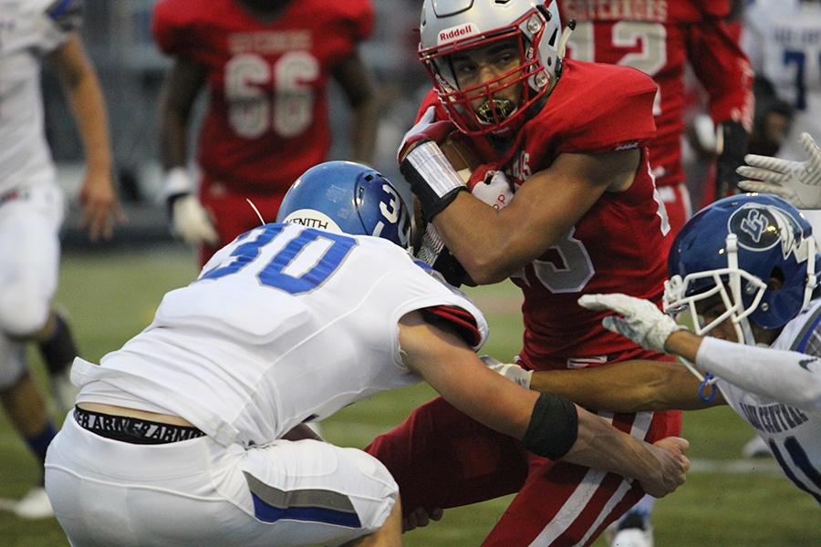 Sam Frank (12) makes a tackle for the defense. The defense had been able to intercept the ball and score a touchdown.