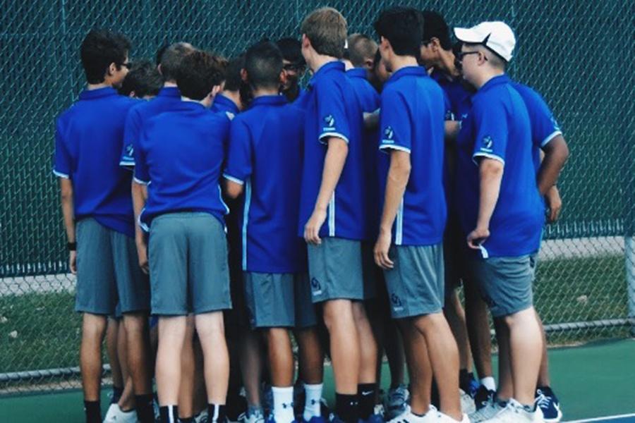 The Lake Central Varsity and JV Tennis teams huddle before their match against Highland. The Lake Central boys defeated Highland 4-1. 