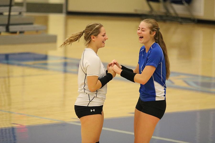 Sam Hurubean (11) and Mackenzie Kusbel (11) laugh during some down time. They played libero and outside hitter, respectively.