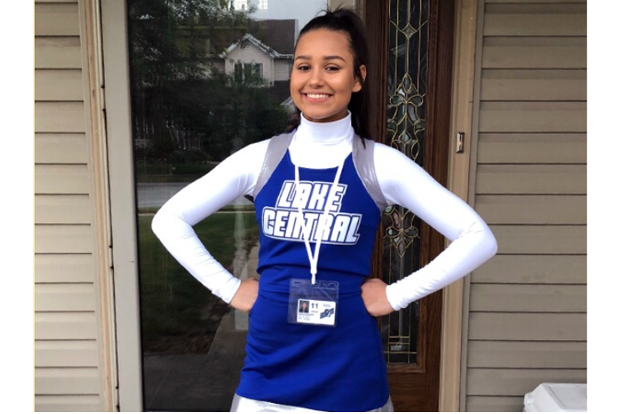 Carissa Mansfield (11) poses in her new cheer uniform before her first game.