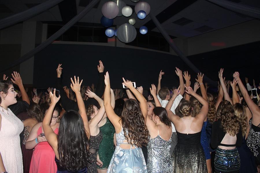 Students throw their hands up in the air. The 
DJ played some hit songs from the 2000’s. Photo by: Sarah Huszar