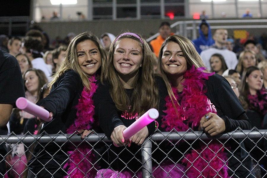  Brianna McCormack (12), Madeline Spoerner (12) and Brenna McCormack (12) pose at the Homecoming game. The game was held Sept. 28 at home. 