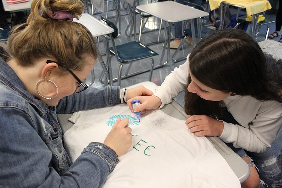 Kali Blankenship (11) and Hayley Matlon (11) upcycle a t-shirt.