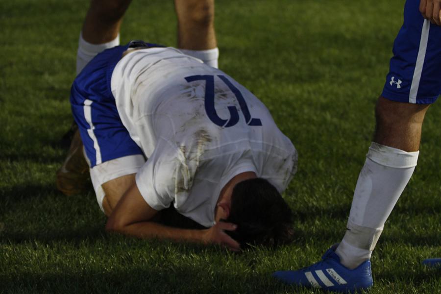 Carson Shrader (12) falls to the ground. This was his last game.