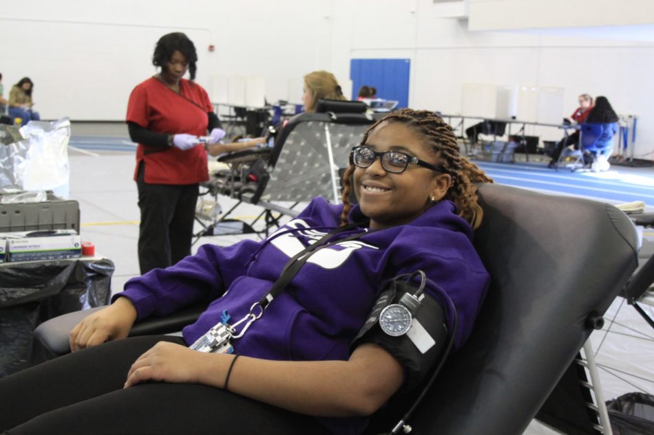 Blessing Nnate (11) is getting her blood pressure taken before she can begin the blood donation process.