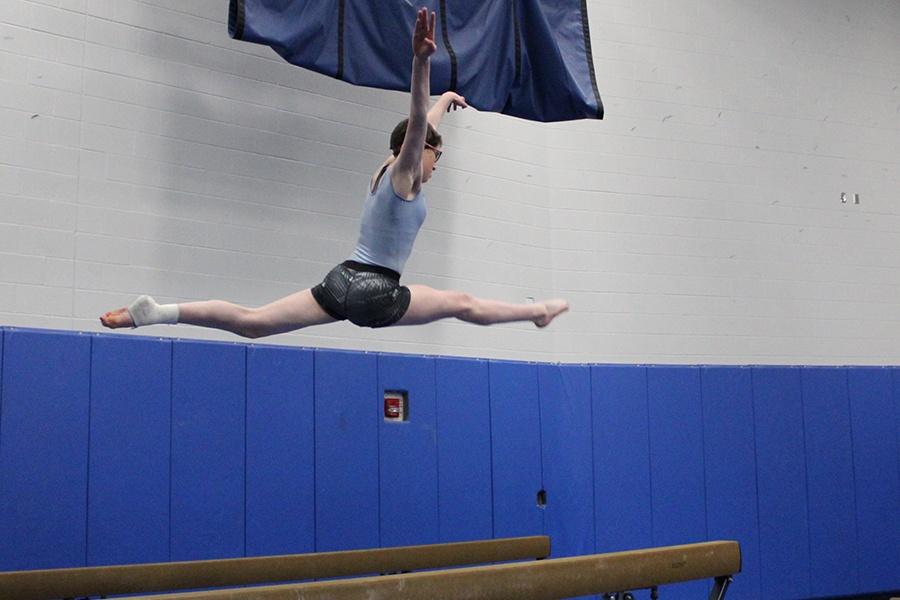 Maddie Bugg (10) jumps across the beam with good technique. She continued to show good form throughout practice.