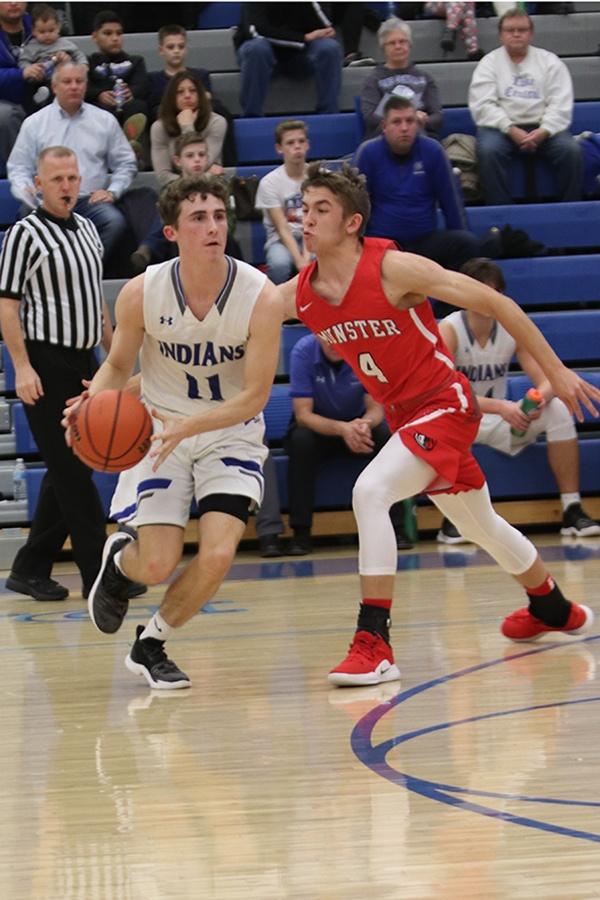 Jack Davis (12) dribbles the ball to get away from a player on the Munter team. Last years game against Munster, Nick Anderson (11) shot a buzzer beater to win. Photo by: Kiley Szatkowski
