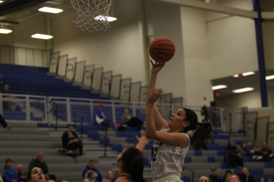Aubrey Rowser (11) shoots a layup over her opponent. The team had many good drives and played well offensively.