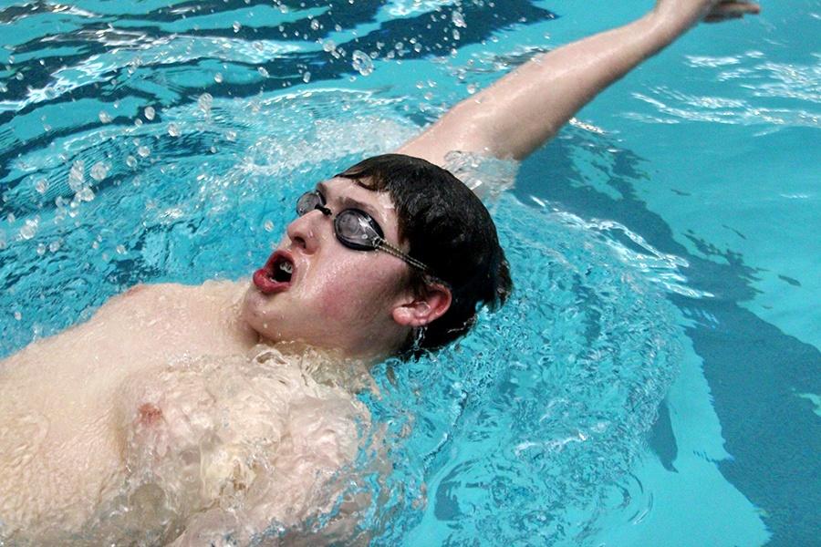 Joshua Burton (11) performs backstroke in his event. He placed 5th in the event.