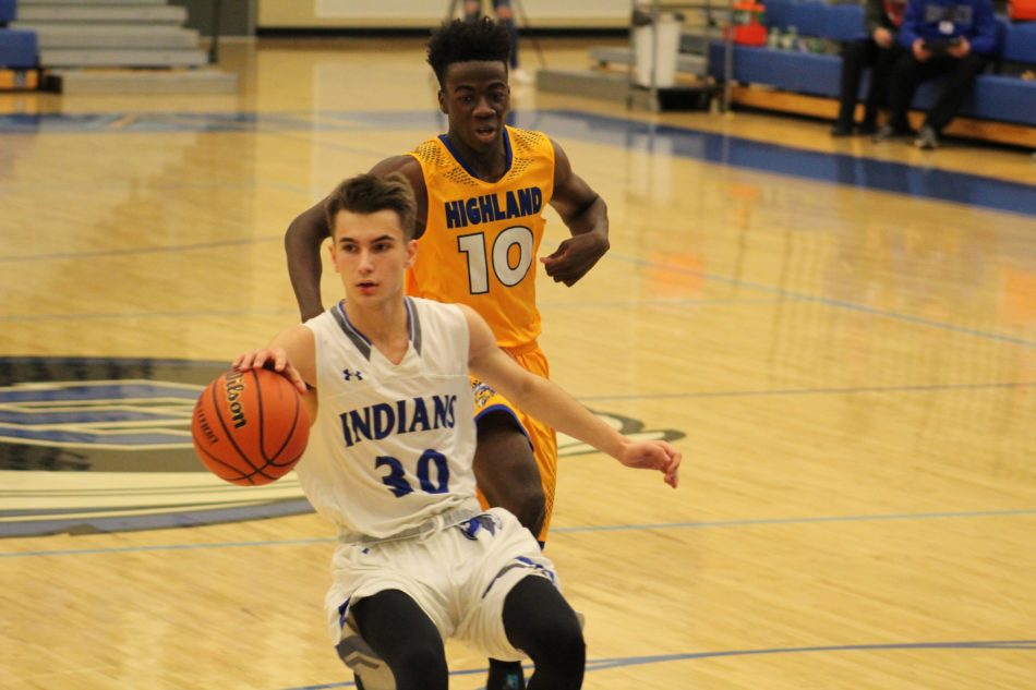 Mark Mileusnic (10) runs with the ball and moves towards the basket. Towards the end, the game was close, but the Indians pulled off a win.