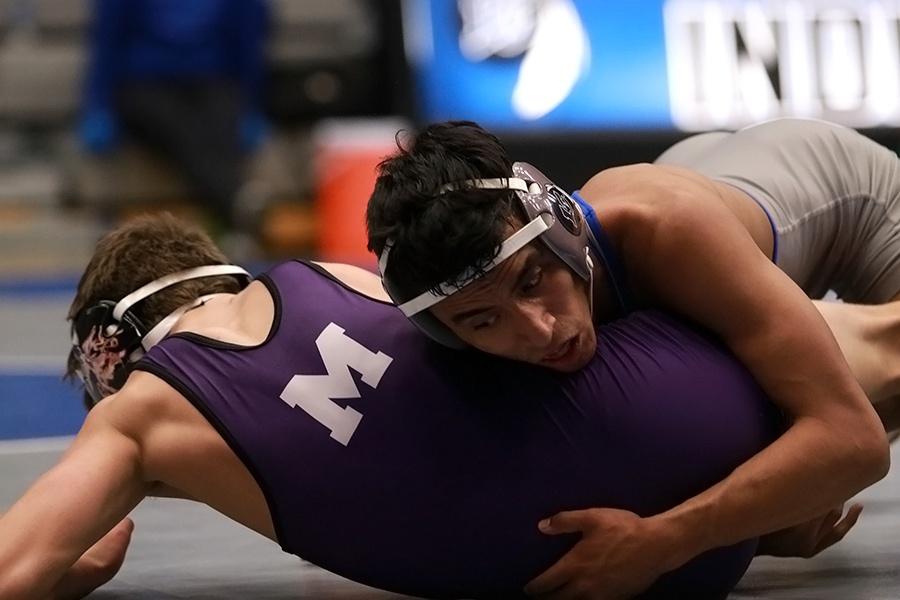 Nicholas+Garcia+%2812%29+takes+down+his+opponent.+Garcia+went+on+to+win+his+match+in+the+285-pound+weight+class.