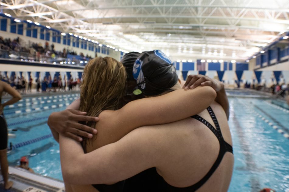 Adisyn Sawaska (10) Jourie Willson (9) Hanna Spoolstra (10) hug after the 400 yard freestyle relay. The girls sat on the first place podium after swimming there best time. 