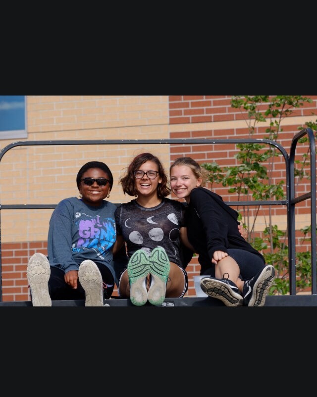 Blessing Nnate (11) is currently taking AP Calculus BC, AP English 11 and AP Government. Nnate, Catherine Economopoulos (11) and Sophia Powers (11) pose outside after Marching Band.