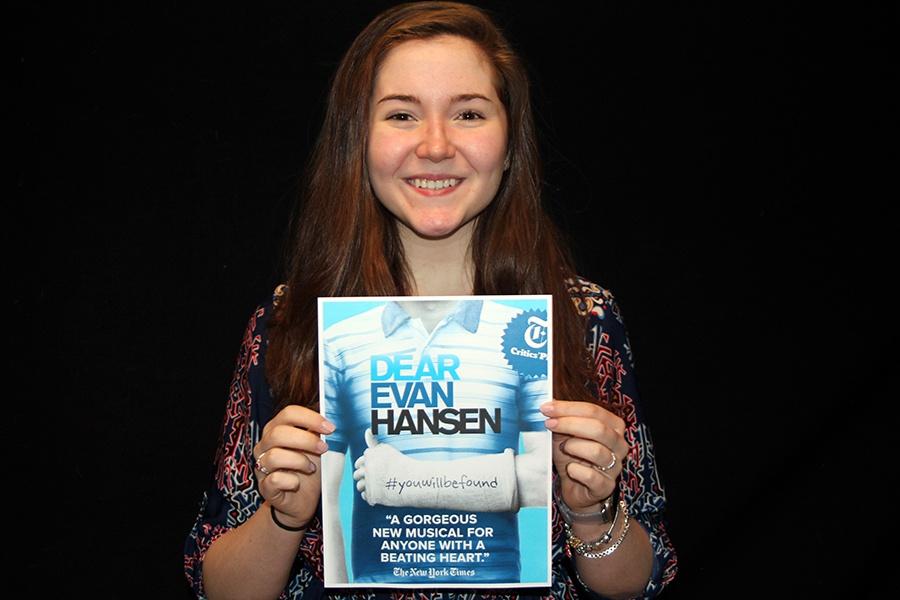 Tenley Edvardsen (10) holds up the Broadway show poster of ‘Dear Evan Hansen.’ 