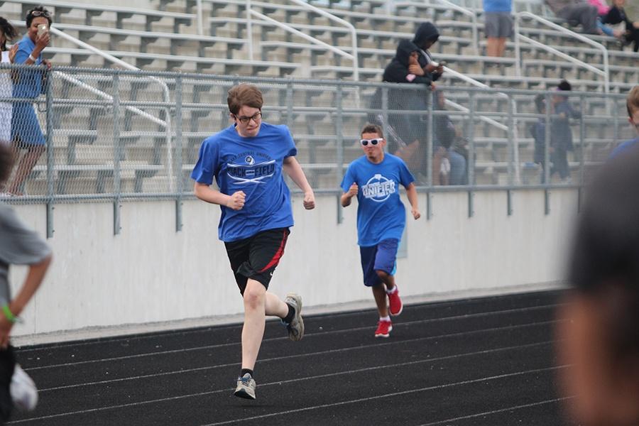 Cole Thompson (9) competes in the 100 meter dash alongside fellow teammate, Kyle Kujawa (12). This was the second meet of the season.