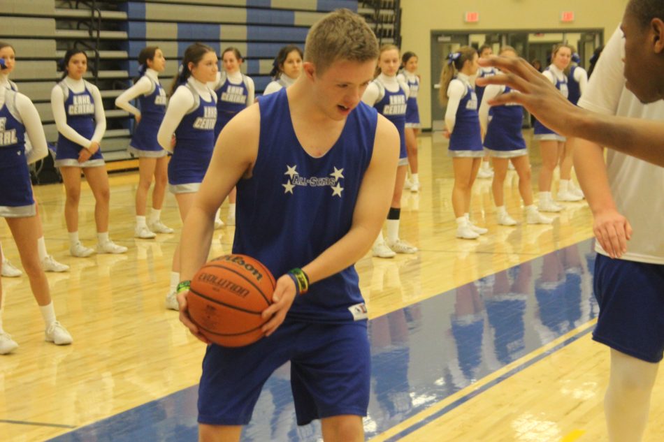Kyle Kujawa moves down the court with the basketball. This was the final game for the teams this year. 