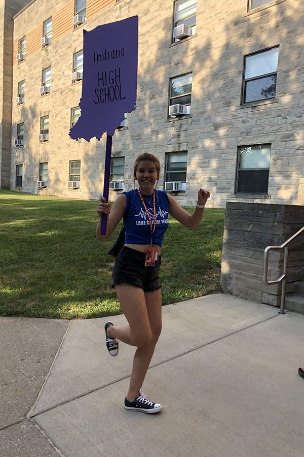 Elizabeth Haberling (12) jumps with her sign for Best Buddies. Haberling was at the state conference.