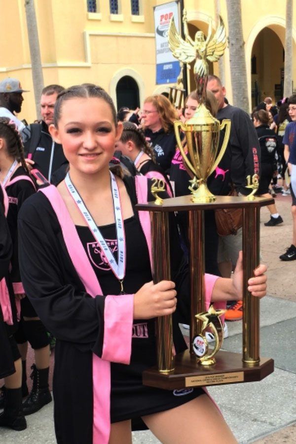 Lillian Gurtatowski (10) poses with her trophy at the national competition in Disney World. She competed with the Tri-Town Raiderettes dance team. 
Photo submitted by: Lillian Gurtatowski (10)