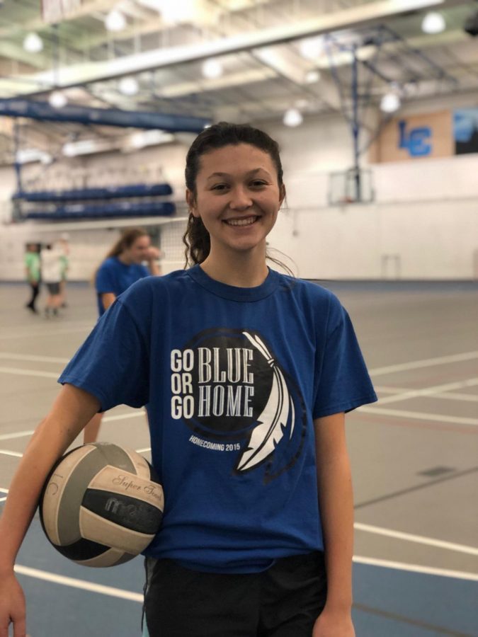  Katharine Mahoney (11) poses with a volleyball before her big game last Tuesday. After playing two games, her team won one and lost the other against their opponents.