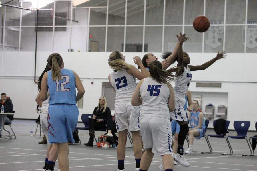 Kai Dilosa (10) jumps into the middle to intersect the basketball. She unsuccessfully lost possession of the ball.  