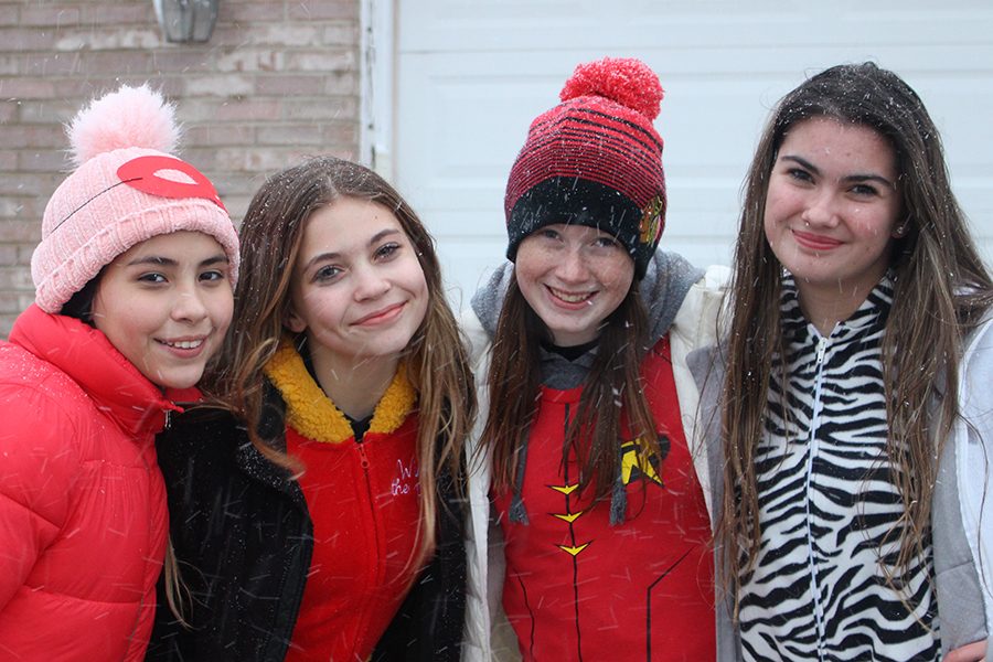 A group of middle school girls pose for a photo. There were several middle school students trick-or-treating.