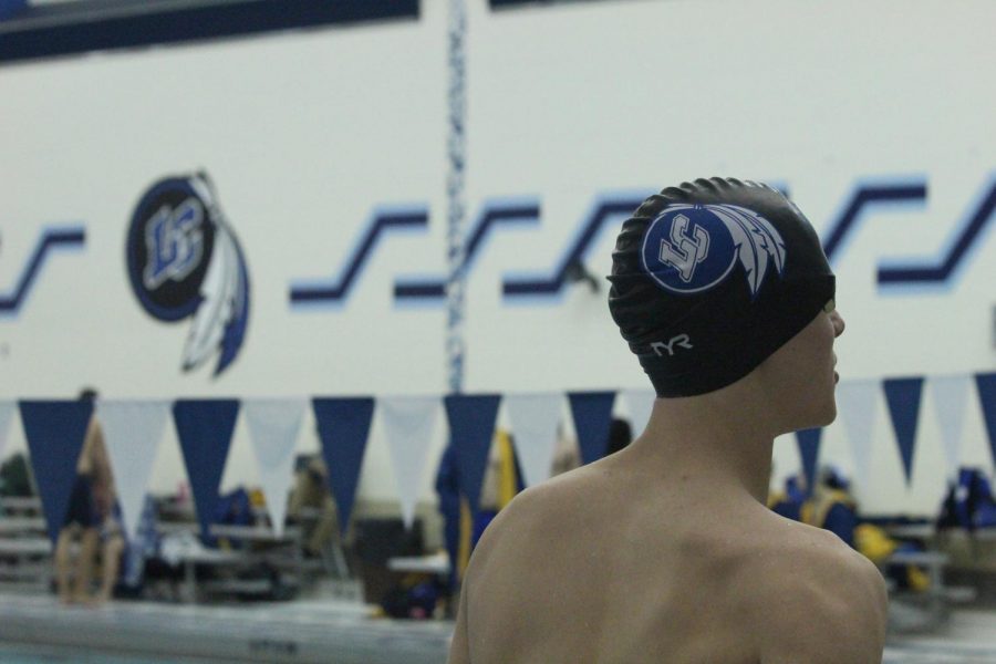 A Lake Central Varsity swimmer looks at the scoreboard to see how well he placed during his race. Lake Central won against Highland with an end score of 144-34.