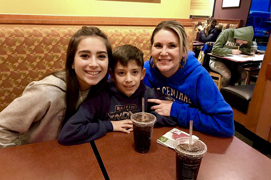 Ava Orueta (11) enjoys a meal with her family at the Best Buddies fundraiser. Orueta came to support as an officer of the club.